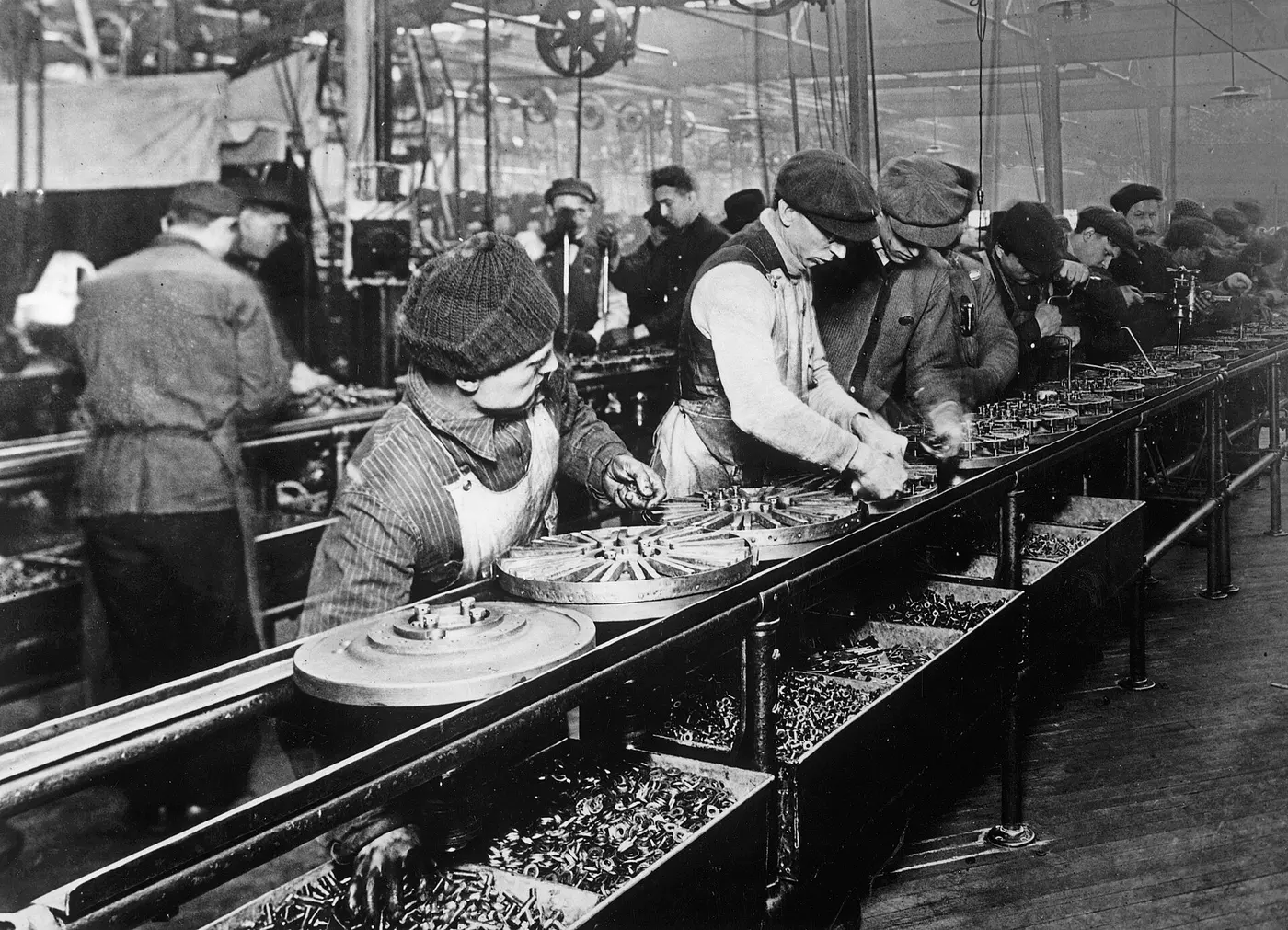 Workers assembling chassis on the Ford line in 1913